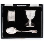 An Elizabeth II silver christening set of egg cup, spoon and napkin ring, initialled I, by William