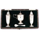 A George VI three piece silver vase shaped condiment set, blue glass liner, pepperette 10.5cm h,