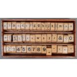 A set of varnished wood and rubber letter and number printing blocks, second quarter 20th c, in