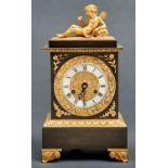 A French ormolu mounted bronze mantel clock, c1830, in Empire style, with winged cherub finial,