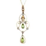 A peridot, split pearl and gold openwork pendant, early 20th c, with split pearl set loop, 50mm,