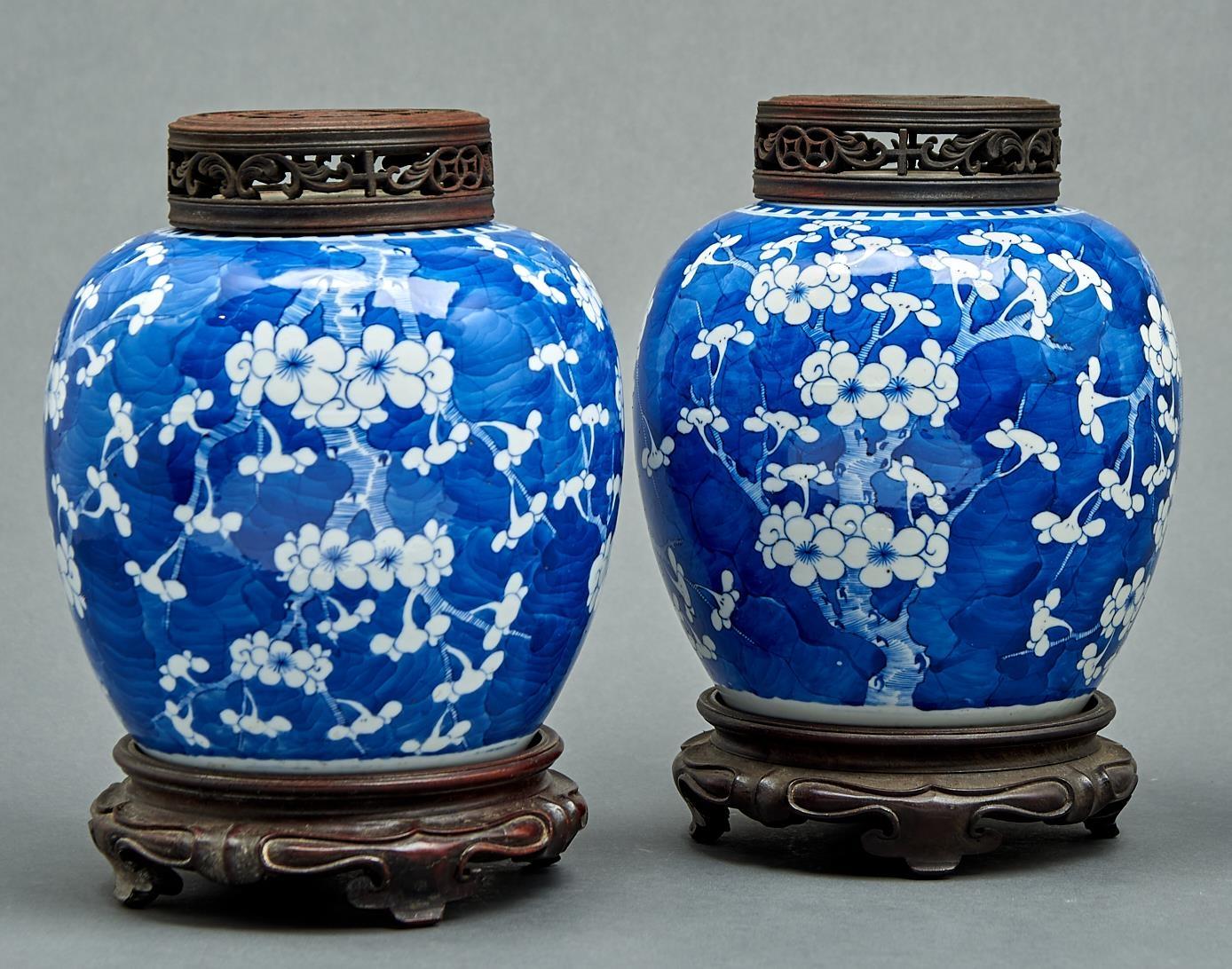 A pair of Chinese blue and white prunus-on-cracked-ice jars, Qing dynasty, 19th c, 20cm h, wood