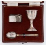 A George VI silver child's egg cup, spoon and napkin ring, egg cup 70mm h, by Deakin & Francis,