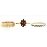 A three colour 9ct gold ring, Sheffield 1994, 4.7g, a garnet cluster ring in 9ct gold and a