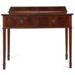 An Edwardian mahogany two drawer side table, c1910, the shaped upstand above a rectangular top