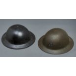 Two World War II steel helmets,  both with suspension webbing and canvas chin strap, 30.5cm diam