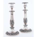 A pair of Sheffield plate candlesticks, c1830, applied with leafage, on gadrooned foot, nozzles,