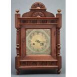 A Victorian oak cased mantel clock, c1890, with arched pediment and bun shaped lacquered brass