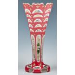 A Bohemian cased glass vase, c1860, of flared shape, overlaid in white and candy pink, enamelled and