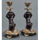 A pair of figural bronze candlesticks, 20th c, in French mid 18th c style, in the form of a semi