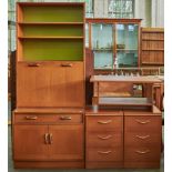 A G-Plan teak wall unit with adjustable shelved back, fall-flap, the projecting base fitted one long