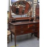 A Victorian walnut dressing table, the central bevelled plate within a frame with swan neck pediment
