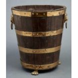 A brass bound oak bucket, elements 19th c, with lion mask handles and paw feet, 34.5cm h Some