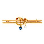 A sapphire and diamond knot-and-bar brooch, early 20th c, 44mm, marked 15ct, .4g Good condition