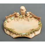 An Austrian porcelain dish, c1910, the rim set with an owl and two owlets, in an old ivory palette