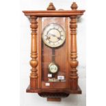 A walnut Vienna wall clock, c1910,  with grid iron pendulum, 62cm h Dial discoloured, case with