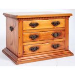 A pine chest of drawers, the rectangular top above a dentil moulded frieze fitted three drawers with