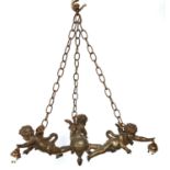 A French spelter gilt and oxidised three cherub chandelier, c1920, suspended from chains, each