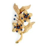 A sapphire spray brooch in 9ct gold, with textured petals and leaves, 54mm, import marked, London