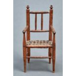 Miniature furniture. An Edwardian spindle turned light wood armchair, c1910, caned seat, 23.5cm h