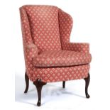A George II style mahogany wing-back armchair on shell carved cabriole forelegs, cushion, seat