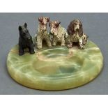 An onyx ashtray, c1930, mounted with four cold painted bronze terriers, 15.5cm diam Paint a little