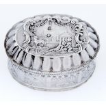 A Dutch decorative oval silver trinket box, the sides decorated with hunting scenes in panels,