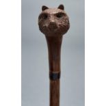 A briar wood walking cane with swiss carved wood bear's head handle, early 20th c, with glass eyes