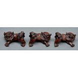 Three Japanese wood netsukes, 20th c, each in the form of a shishi, 56mm l, unsigned Good condition