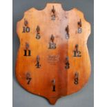 A shield shaped and varnished light wood wall quoites board, "The Club", by F H Ayres Limited