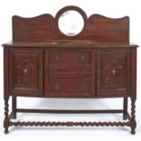 An oak sideboard, c1920, with round mirror inset back, 130cm h; 44 x 136cm Mirror silvering damaged