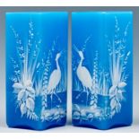 A pair of aesthetic white enamelled turquoise glass square vases, c1880, painted with a bird in a