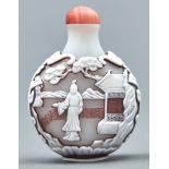 A Chinese triple overlay cameo glass snuff bottle, 20th c, in opal glass overlaid in pale brown