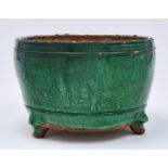 A Chinese green glazed biscuit tripod censer, Ming dynasty, early 17th c, the rounded sides