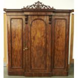 A Victorian figured mahogany breakfront wardrobe, c1870, the top with fret pierced panel centred