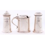 A George V three piece three piece silver condiment set, the mustard pot in the form of an 18th c