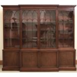 A George III mahogany breakfront library bookcase, c1800, the upper part with cavetto cornice and
