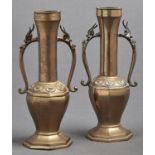 A pair of Chinese brass vases, third quarter 19th c, the tall tubular necks spreading at the top and