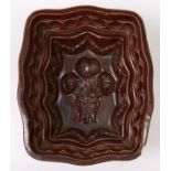 A British brown stoneware jelly mould, c1870, 21cm l Chip on exterior