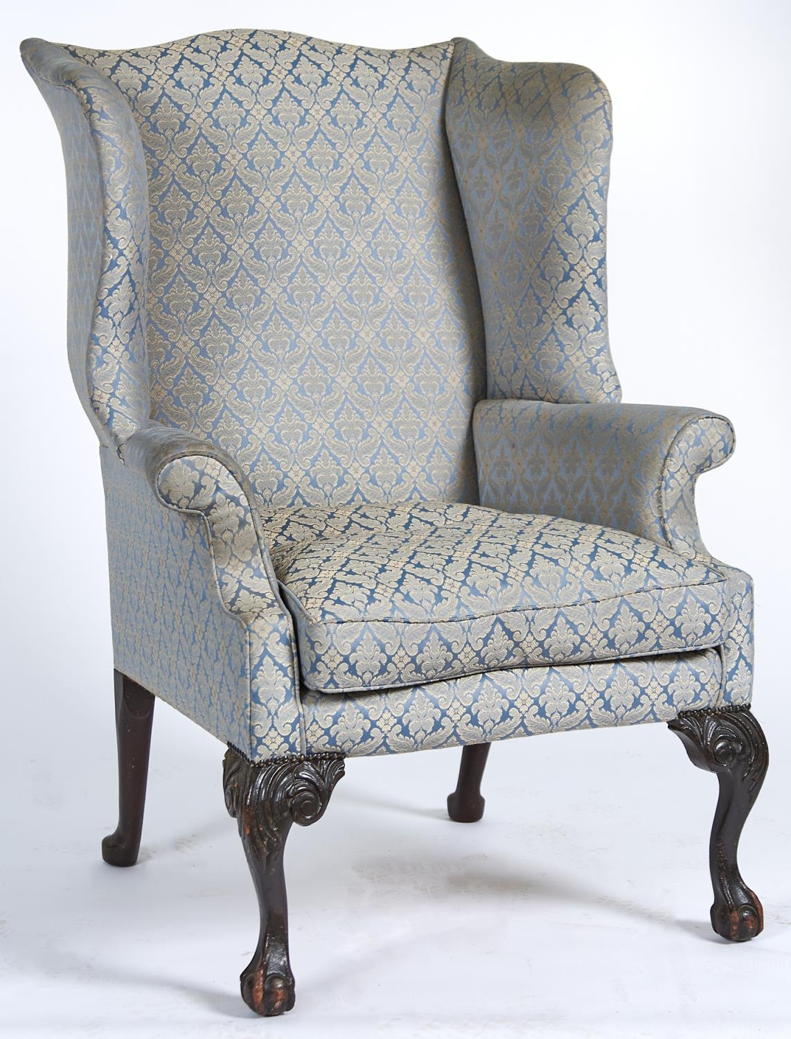 A George II mahogany framed wingback armchair, c1770, the serpentine shaped back, wings, arms and