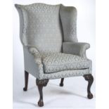 A George II mahogany framed wingback armchair, c1770, the serpentine shaped back, wings, arms and