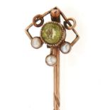 A gold peridot and pearl set stick pin, marked 9ct, 1g