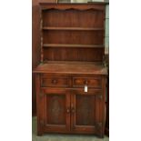 A panelled oak dresser and rack, the lower part with carved doors, 171cm h; 93cm w Minor scuffs