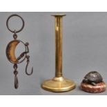 A late 17th c brass ejector candlestick,  with circular drip pan, the cylindrical stem with aperture