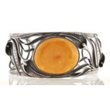 A silver bangle set with large amber cabochon, 40.5g