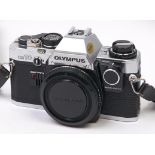 An Olympus OM10 SLR film camera body, with manual adaptor In apparently working order, good