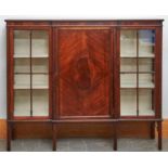 An Edwardian mahogany breakfront display cabinet, c1910, the panelled centre door with central