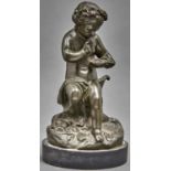 A bronze statuette of a child, late 19th c, seated on a stump holding a bird's nest, even greenish