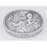 A German silver trinket box, the lid die stamped with putto on a cloud, the sides with guilloche,