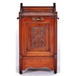 A Victorian mahogany coal box, the front hinged door inset with carved panel, on brown pottery